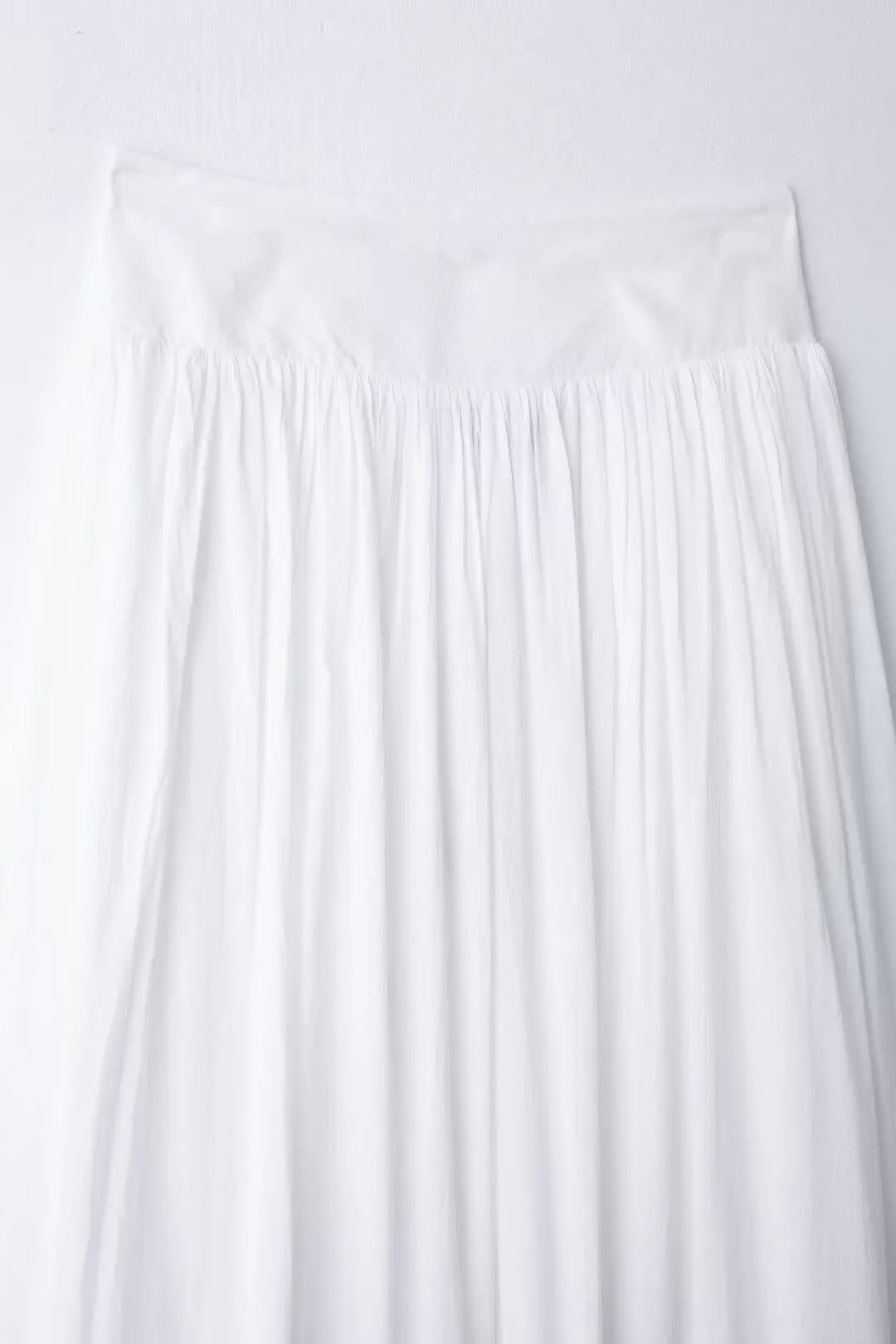 White pleated skirt on a white background