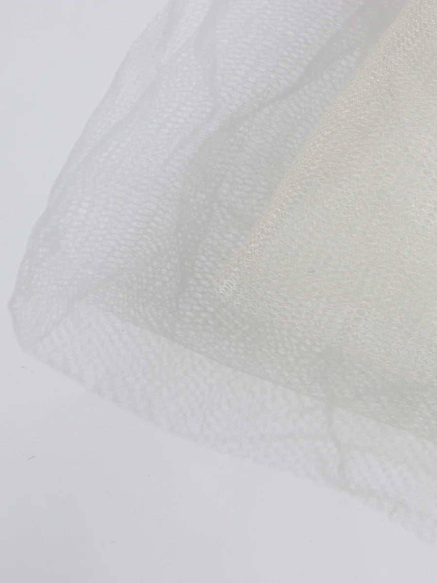 Close-up of textured white fabric on a light gray background