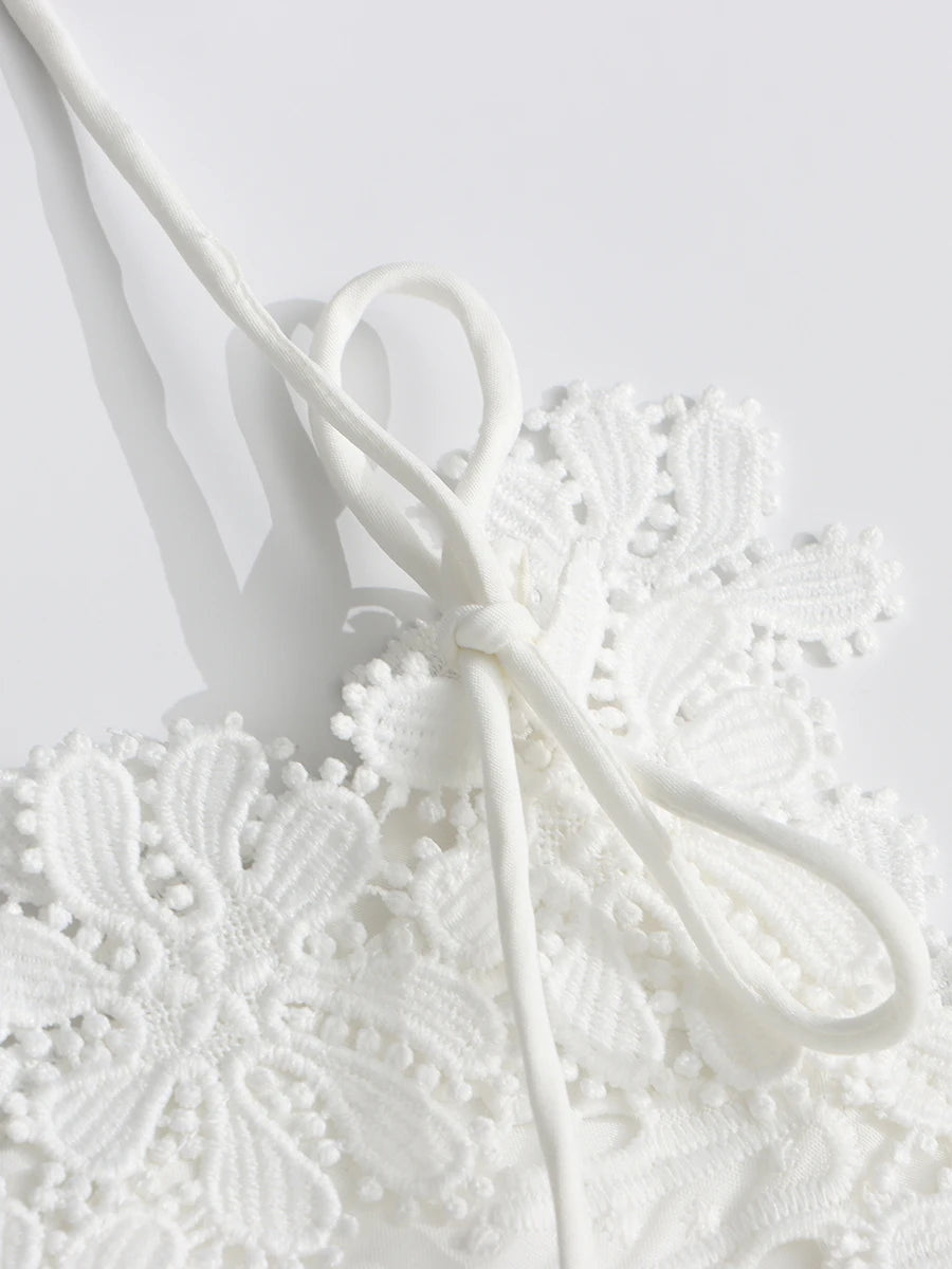 Close-up of a white lace doily on a light gray background