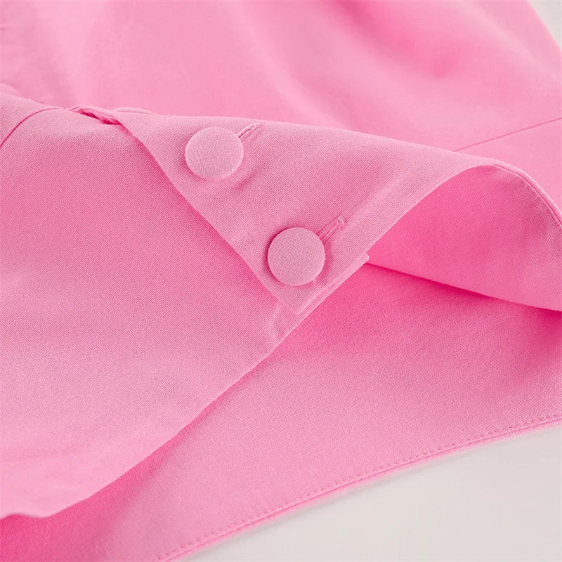 Close-up of a pink fabric with buttons on a white background