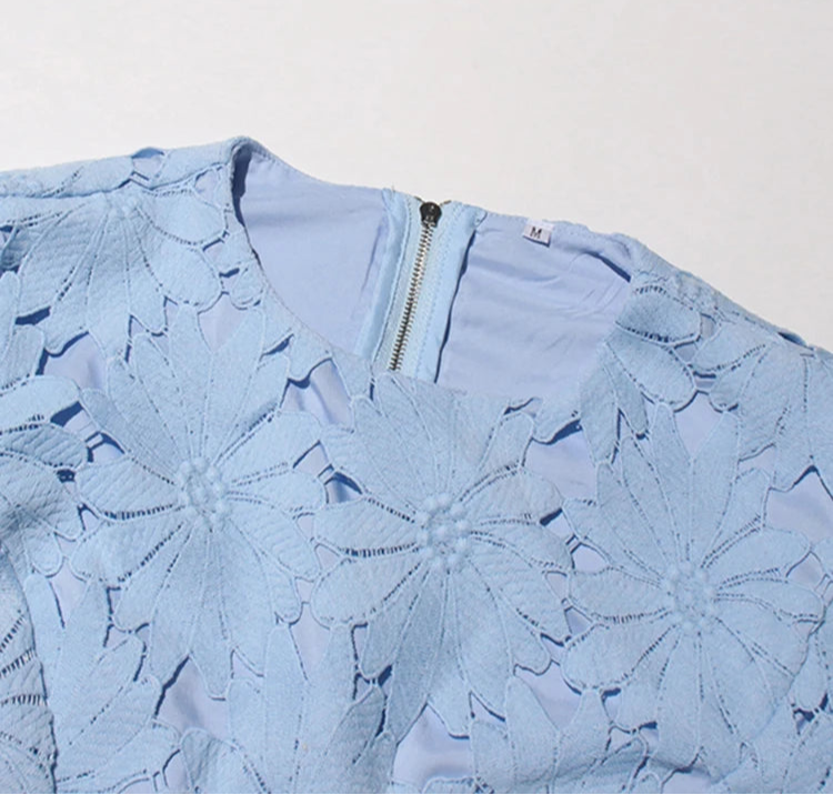 Light blue floral dress with a zipper on a light gray background