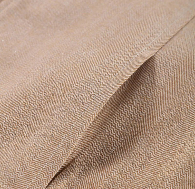 Close-up of beige fabric with a herringbone pattern