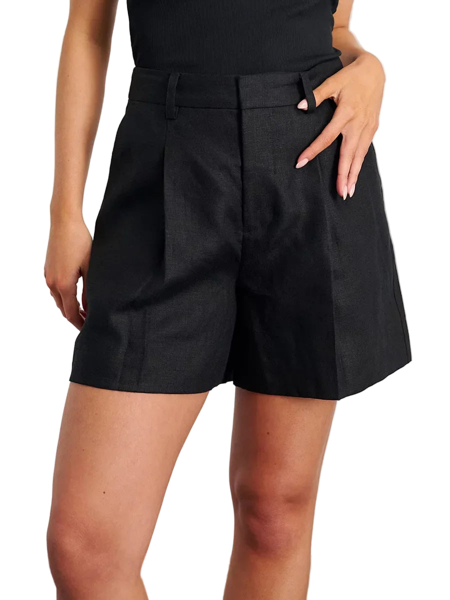 Person wearing black shorts on a plain background