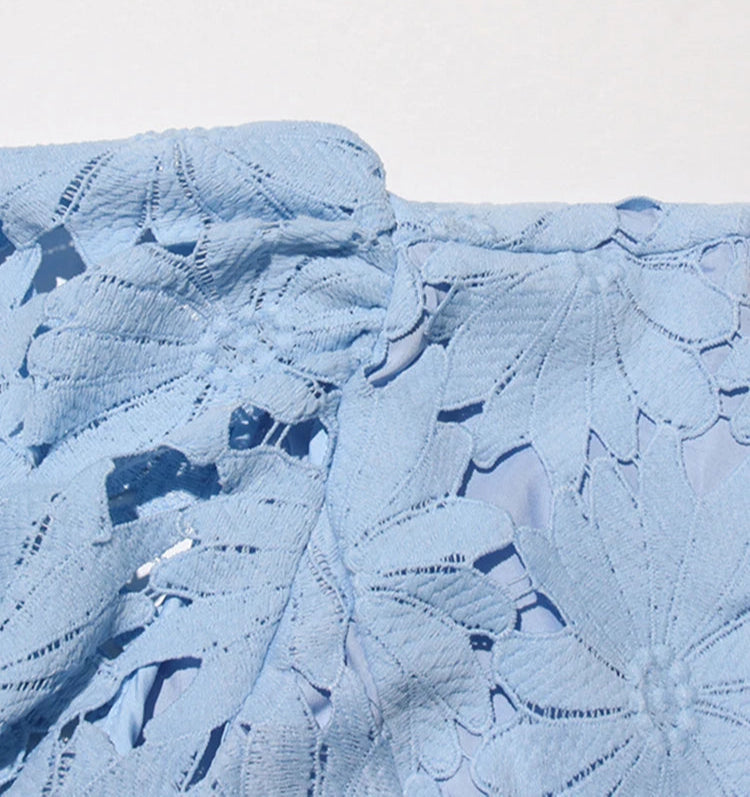 Close-up of a textured blue fabric with a pattern on a light gray background