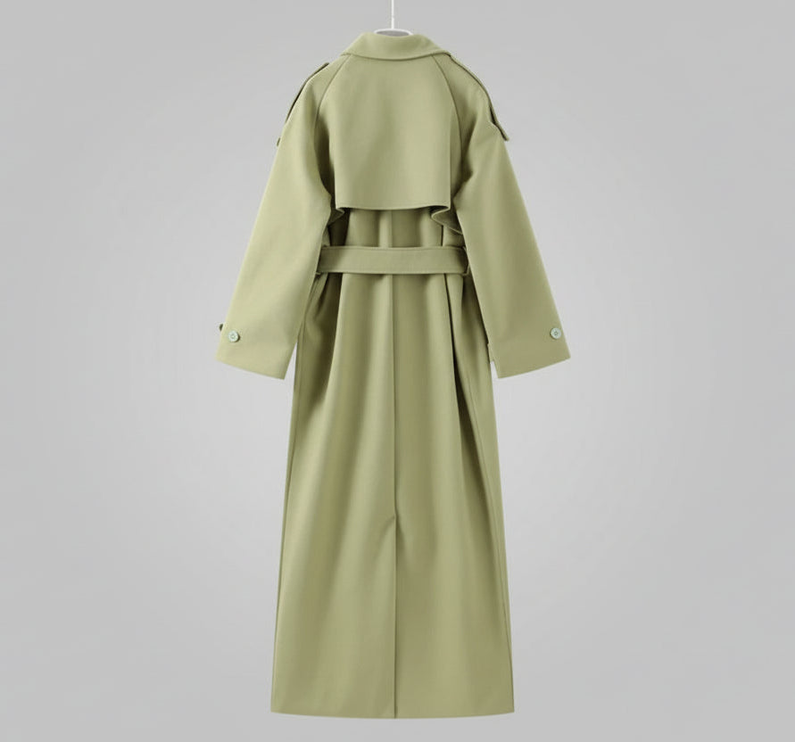 Green coat displayed on a hanger against a neutral background