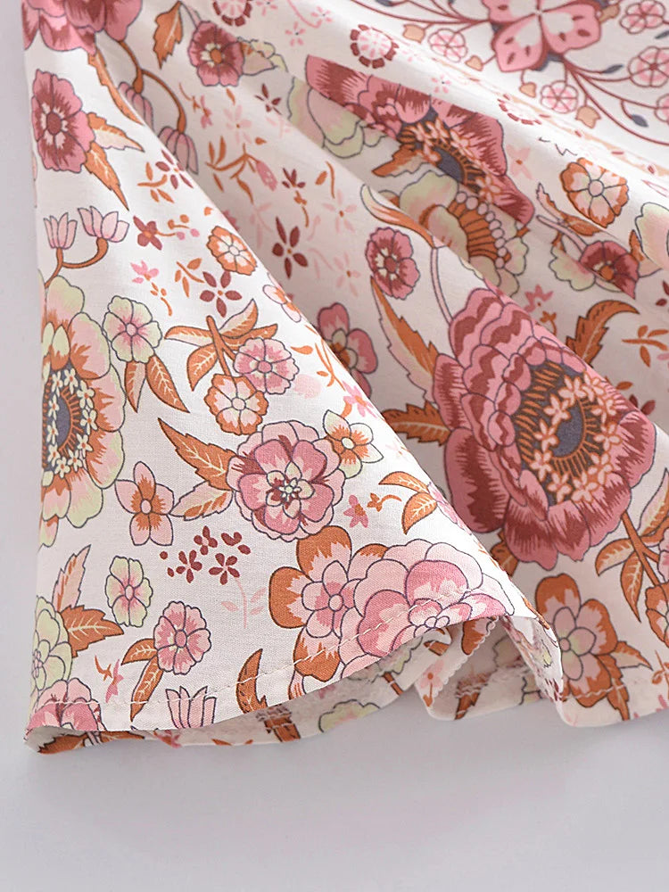 Floral fabric with pink and orange flowers on a white background