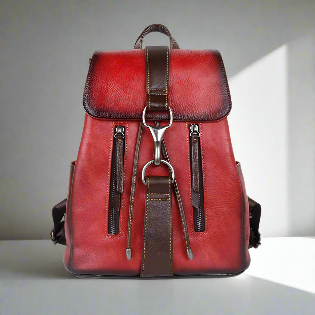Red leather backpack with brown accents on a white background