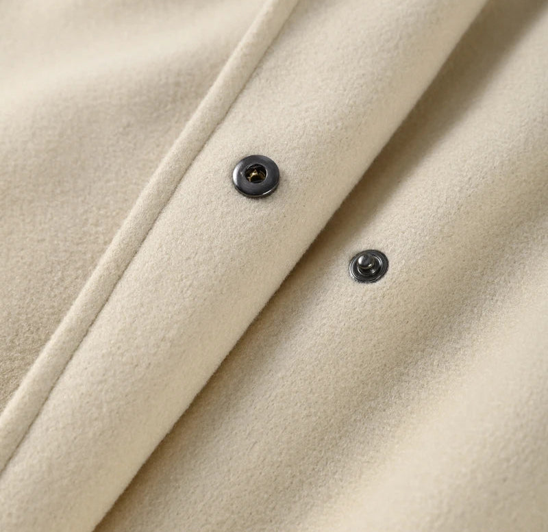 Close-up of beige fabric with buttons on a white background