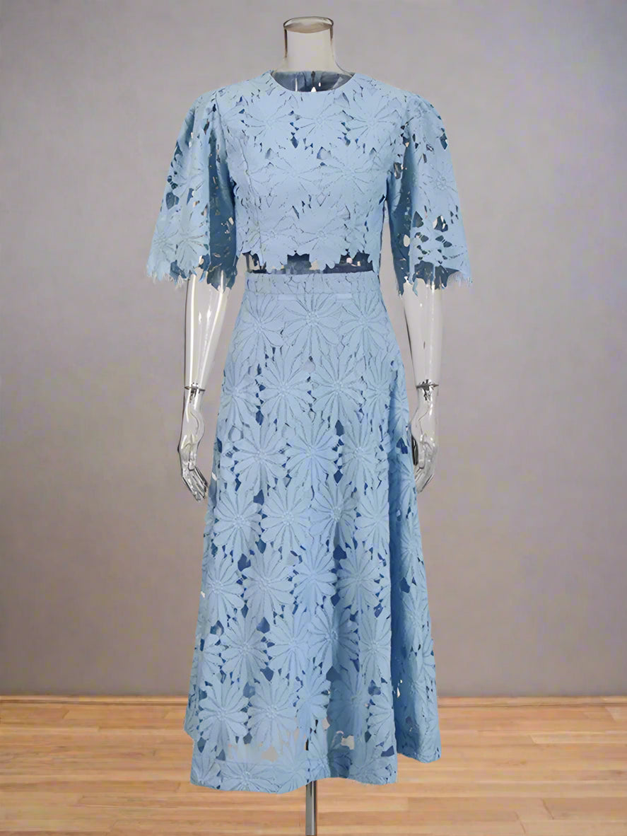 Light blue lace dress on a mannequin against a white background
