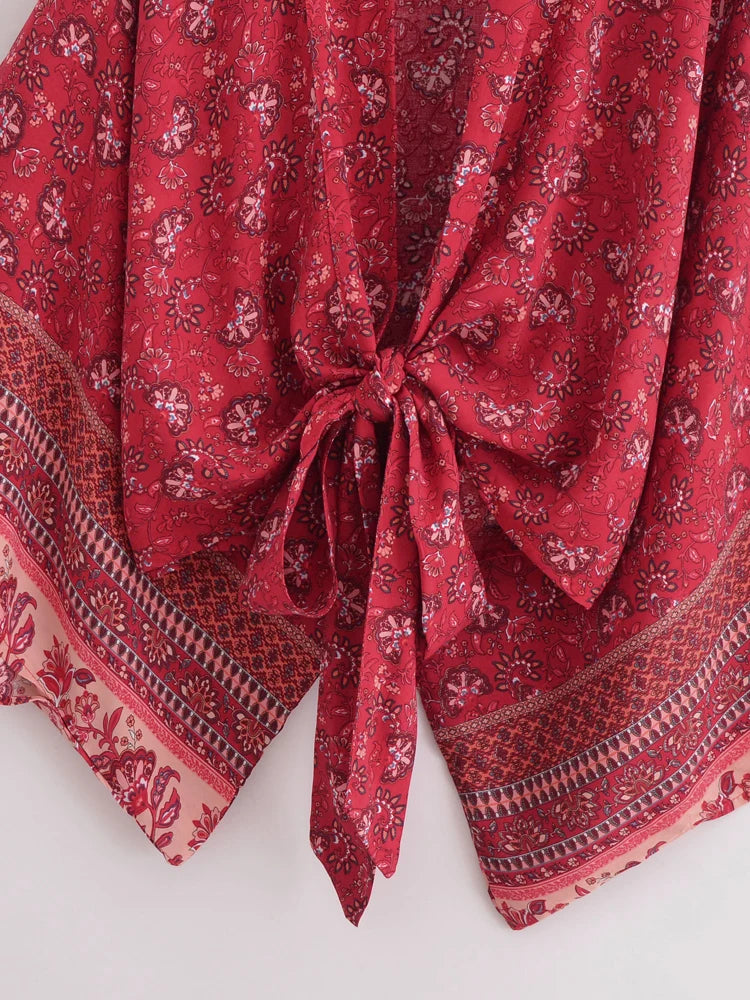 Red patterned fabric with a knot on a white background