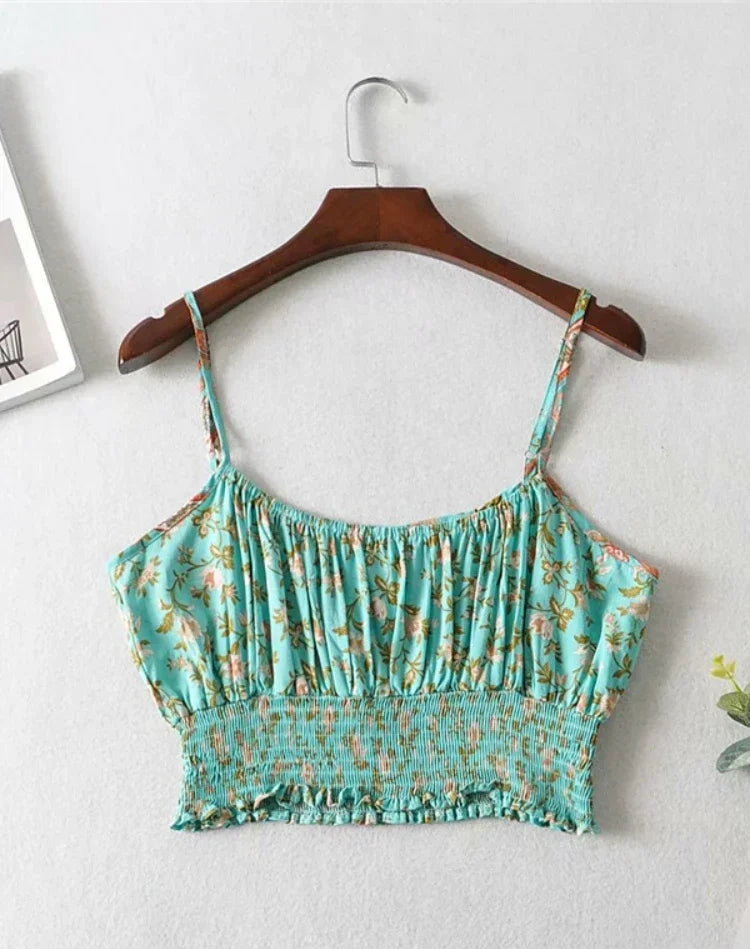 Green floral crop top on a hanger against a white background