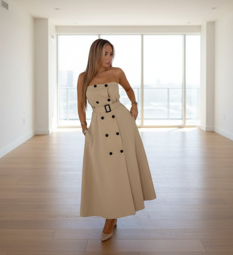 Beige strapless dress with black buttons on an empty penthouse