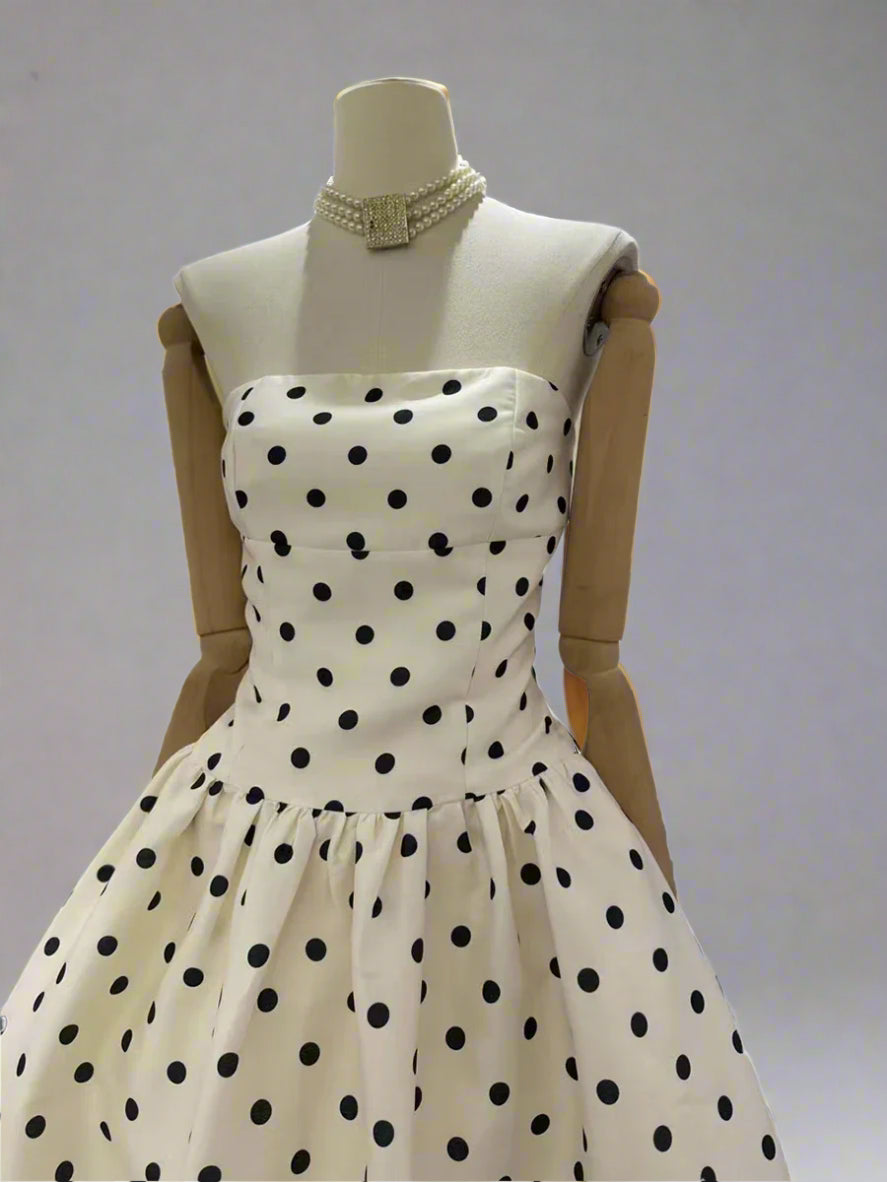Mannequin wearing a polka dot dress on a white background