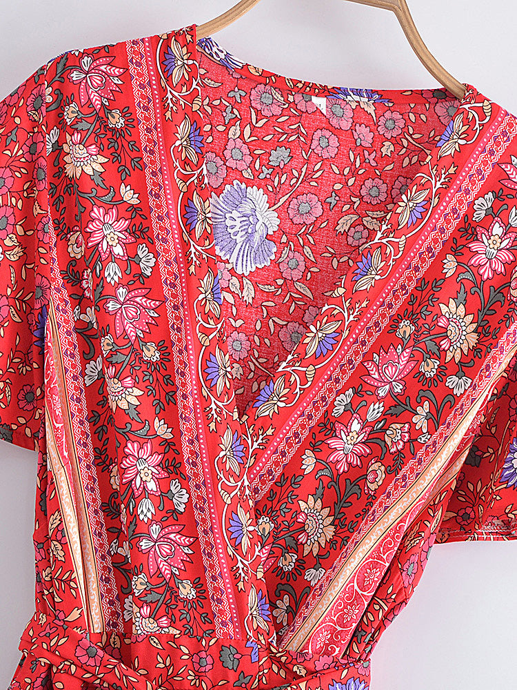 Red floral patterned fabric on a hanger against a white background