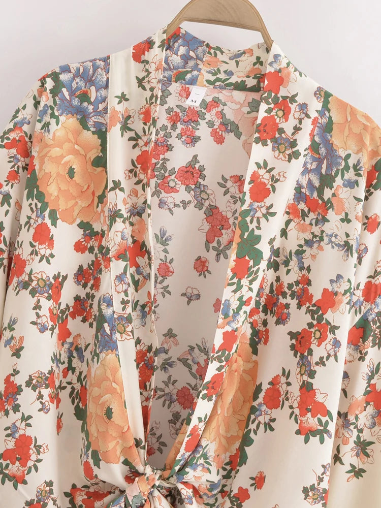 Floral patterned garment on a hanger against a neutral background