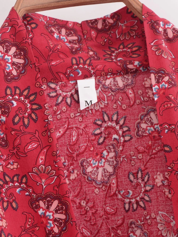 Red patterned shirt with a tag on a white background