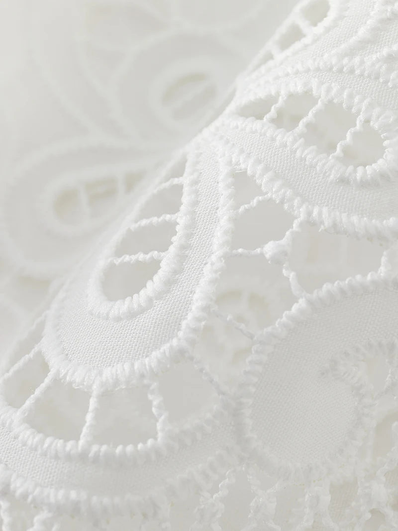 Close-up of white lace fabric with intricate patterns