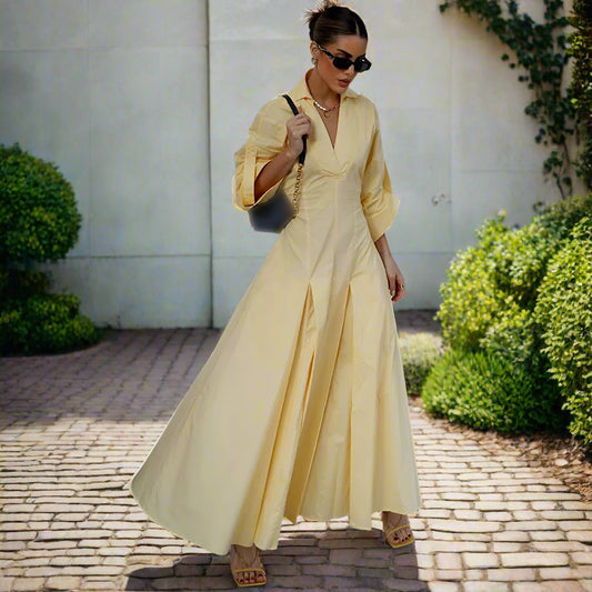 Woman wearing a yellow dress with a backyard garden in the background