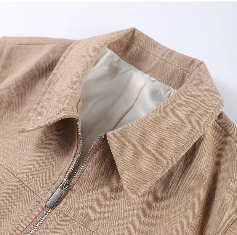 Close-up of a beige jacket with a zipper on a white background