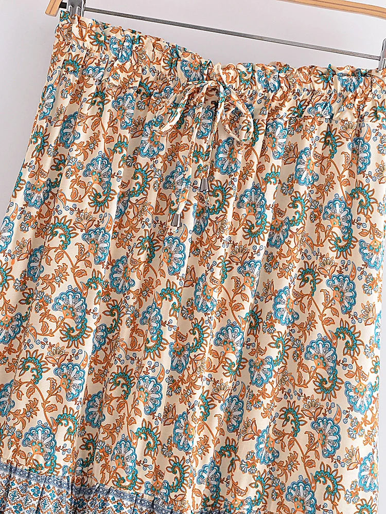 Floral patterned curtain on a rod with a neutral background