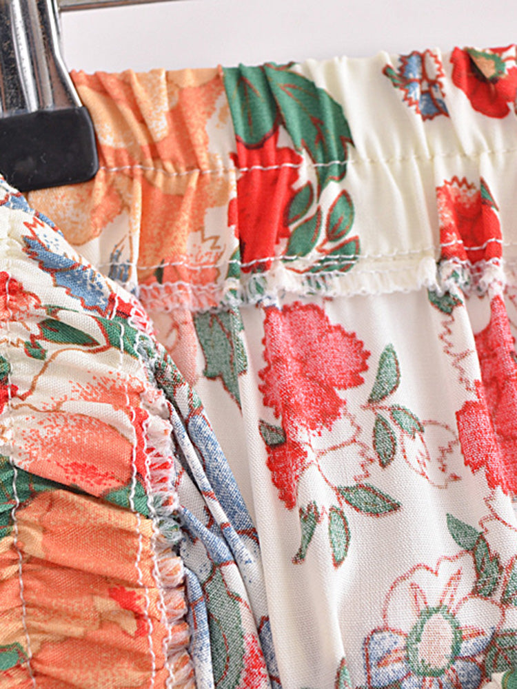 Close-up of a floral dress with ruffles on a hanger.
