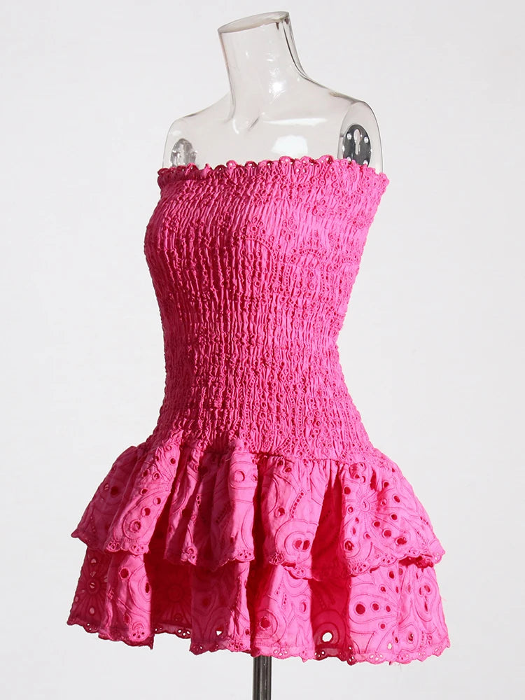 Pink dress on a mannequin against a white background