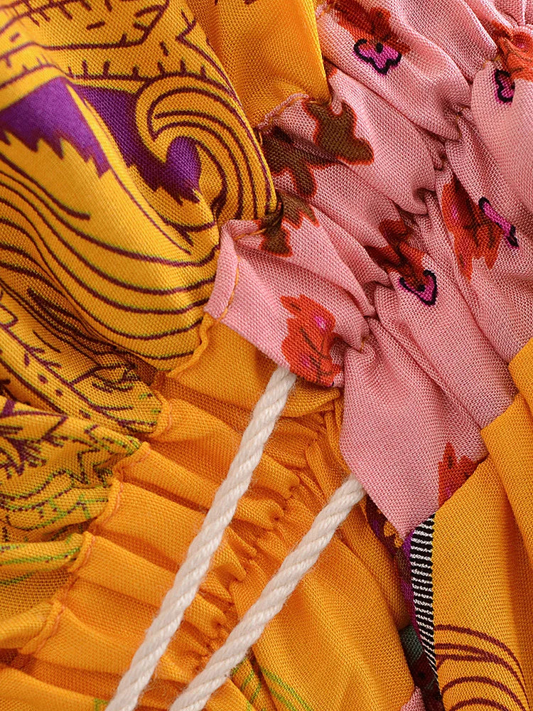 Close-up of colorful fabric with patterns and a white cord.