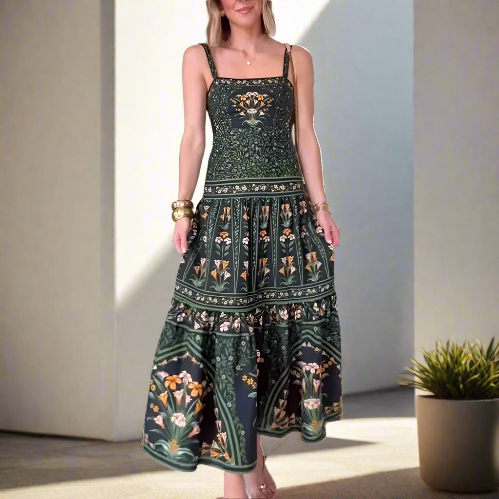 Woman wearing a green floral dress standing in a room with white walls and tiled floor.