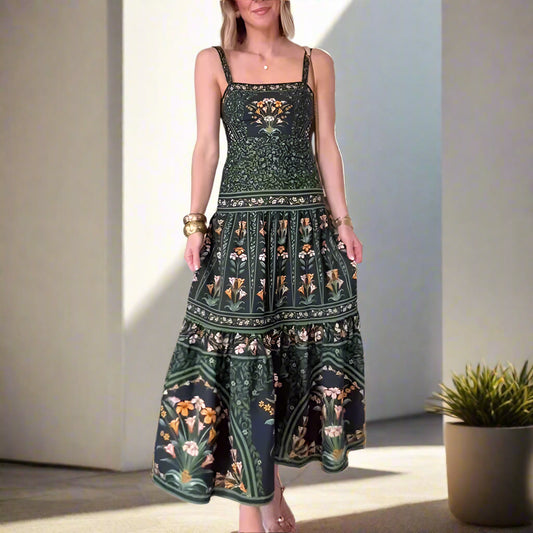 Woman wearing a green floral dress standing in a room with white walls and tiled floor.