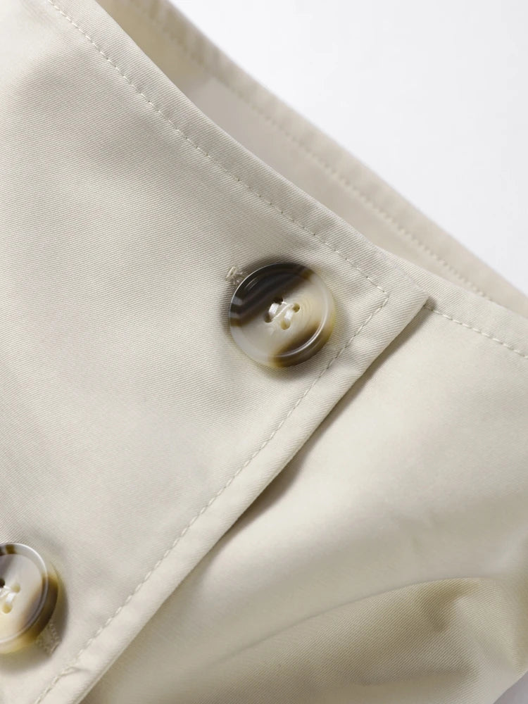Close-up of a beige fabric with buttons on a white background