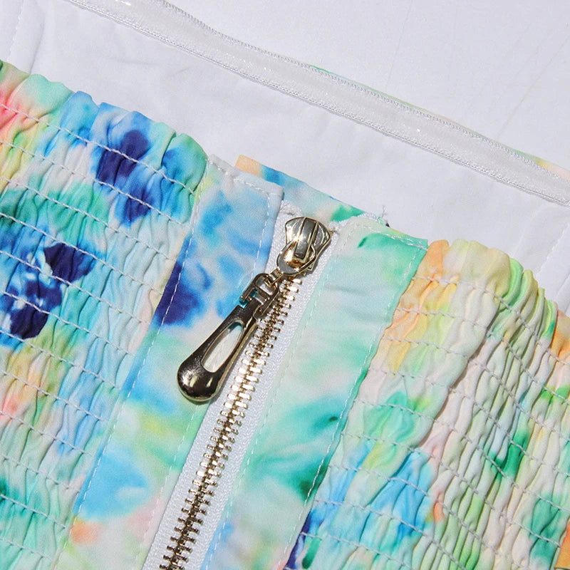 Close-up of a colorful quilted fabric with a zipper on a white background