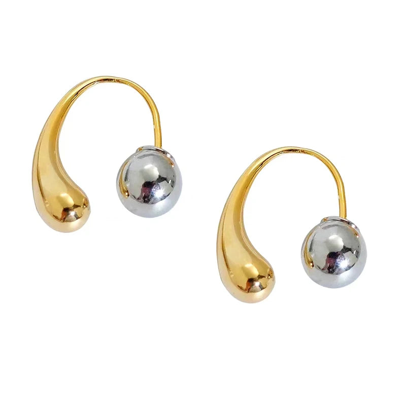 Pair of gold and silver hoop earrings on a white background