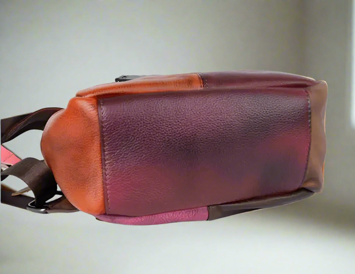 Brown leather bag with a strap on a white background