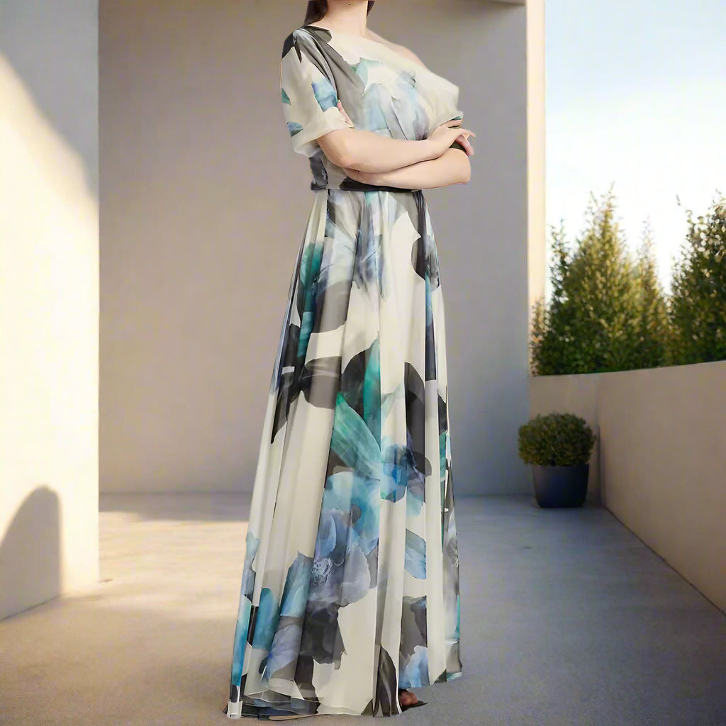 Long, abstract-patterned dress worn by a model on a plain background
