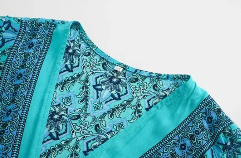 Teal and black patterned fabric on a white background