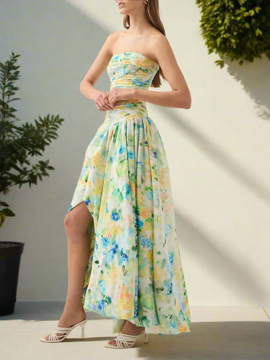 Woman wearing a floral strapless dress with a slit on a backyard garden, sunny day