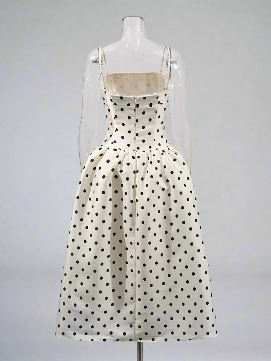 Polka dot dress on a mannequin against a white background