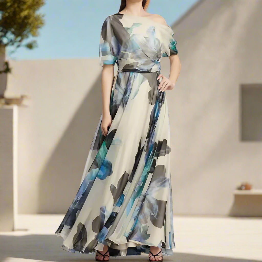 Woman wearing a long, off-shoulder dress with abstract pattern on a plain background