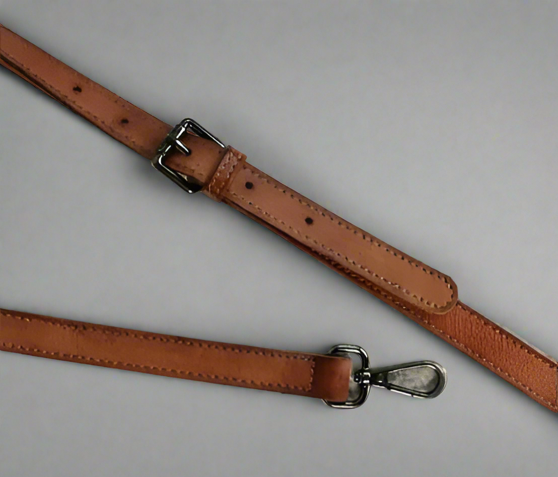 Brown leather shoulder strap with a buckle 