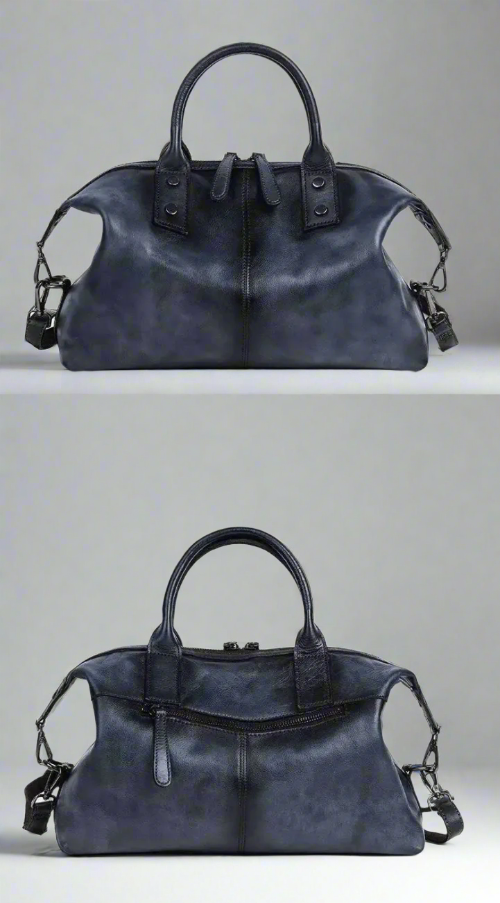 Black leather handbag with multiple handles on a white background