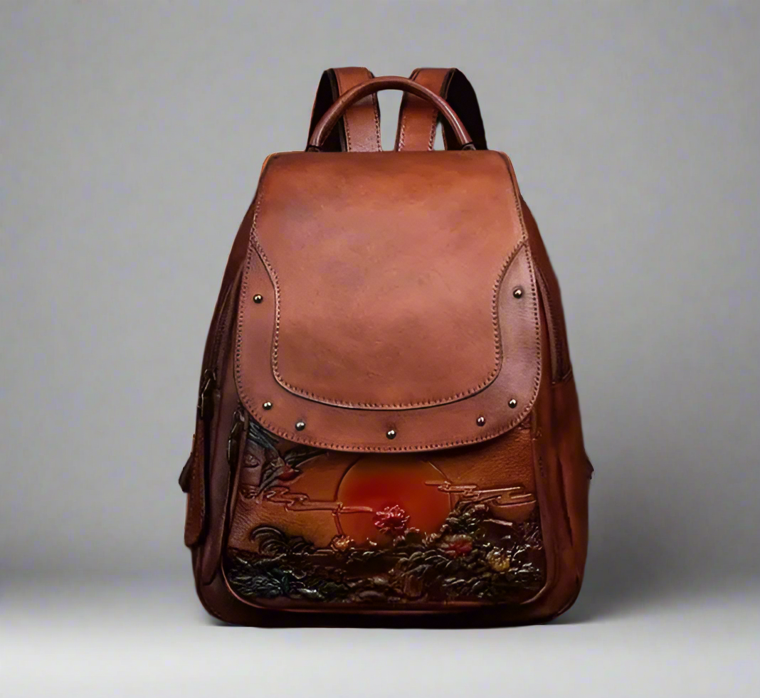 Brown leather backpack with artistic design on a light background