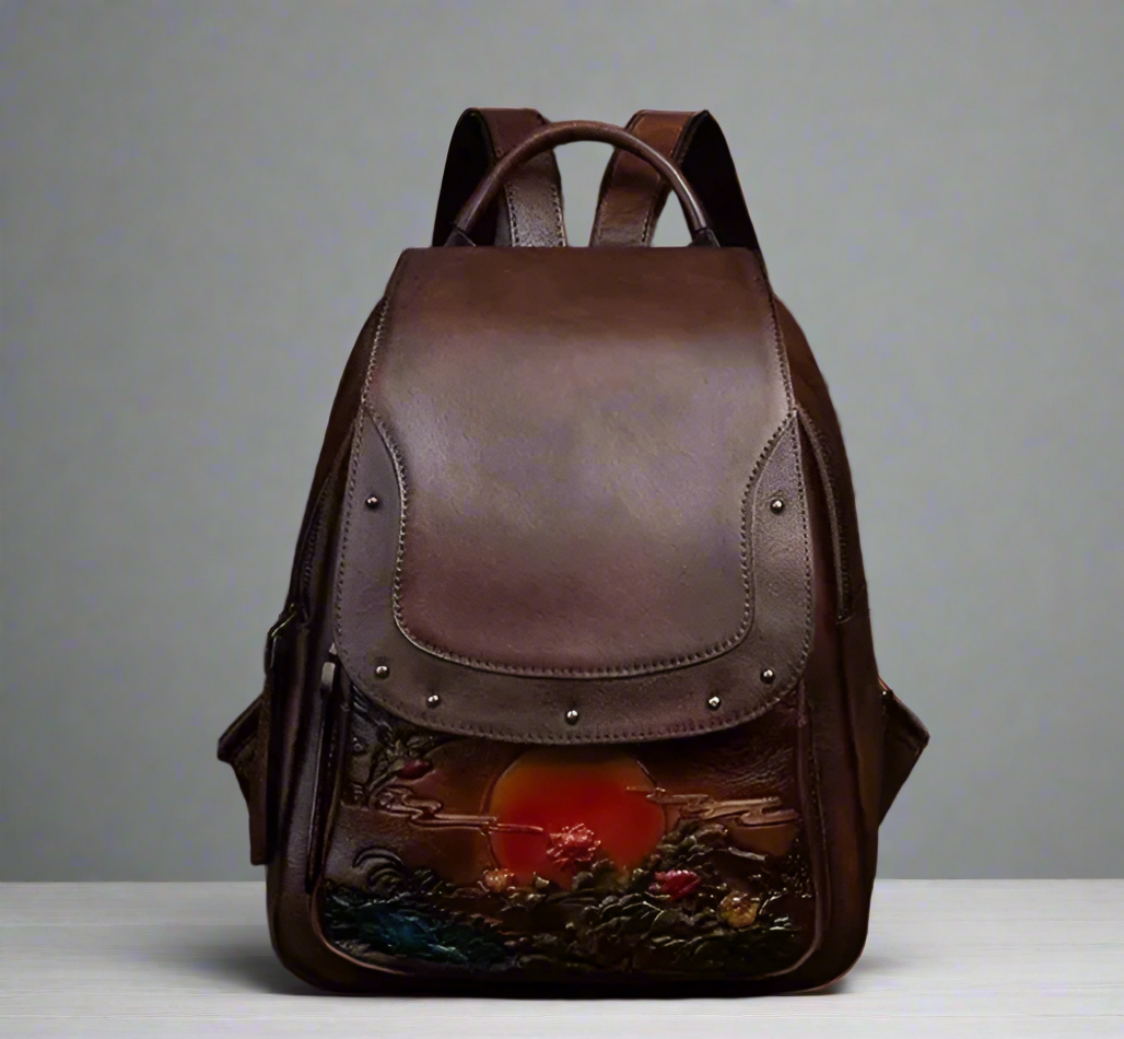 Brown leather backpack with artistic design on a light background