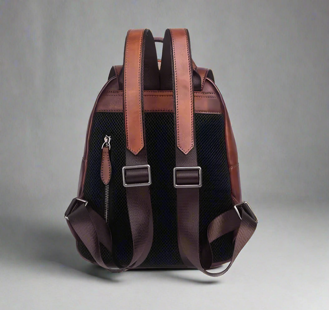 Brown backpack with leather straps on a white background