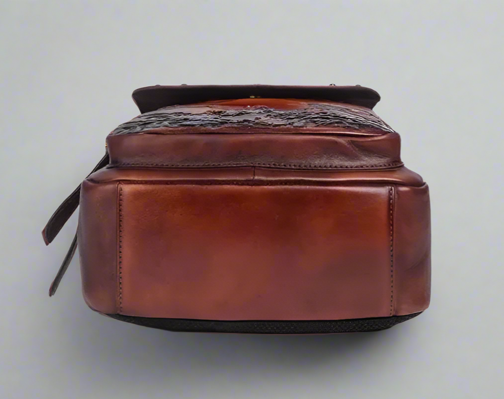 Two brown leather bags, one with floral design on a white background